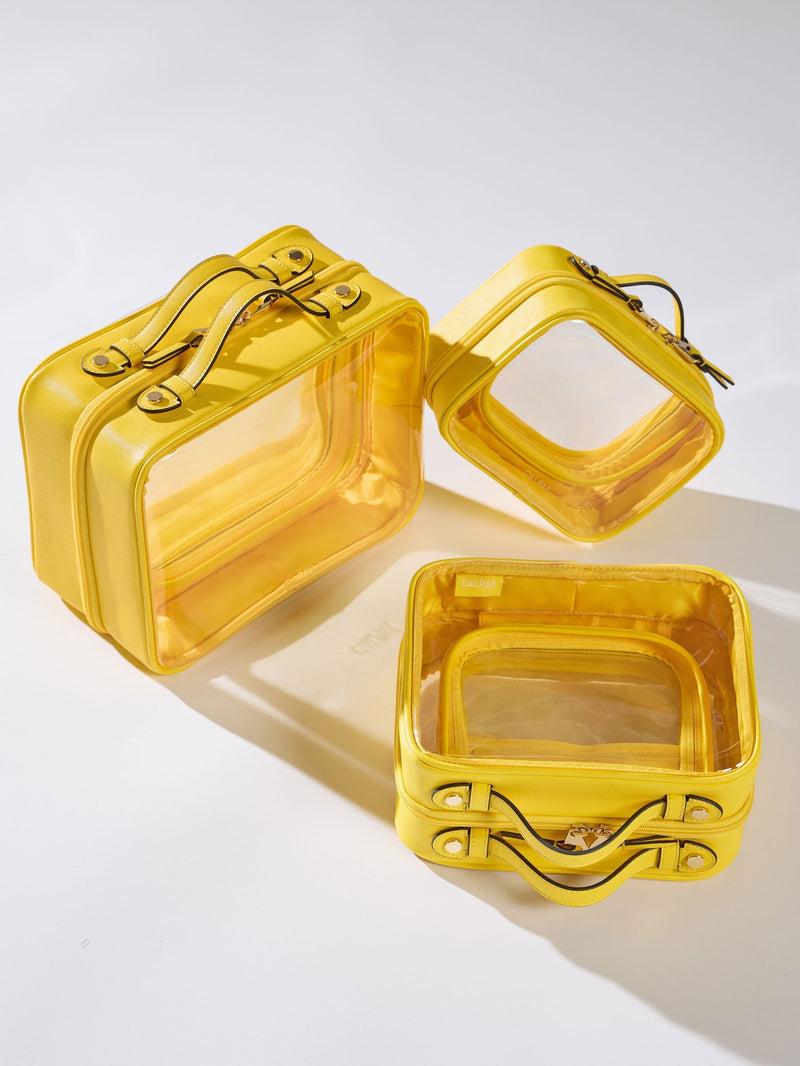 Yellow CALPAK Clear Cosmetic Cases in Medium, Large, and Small for organizing skin care items