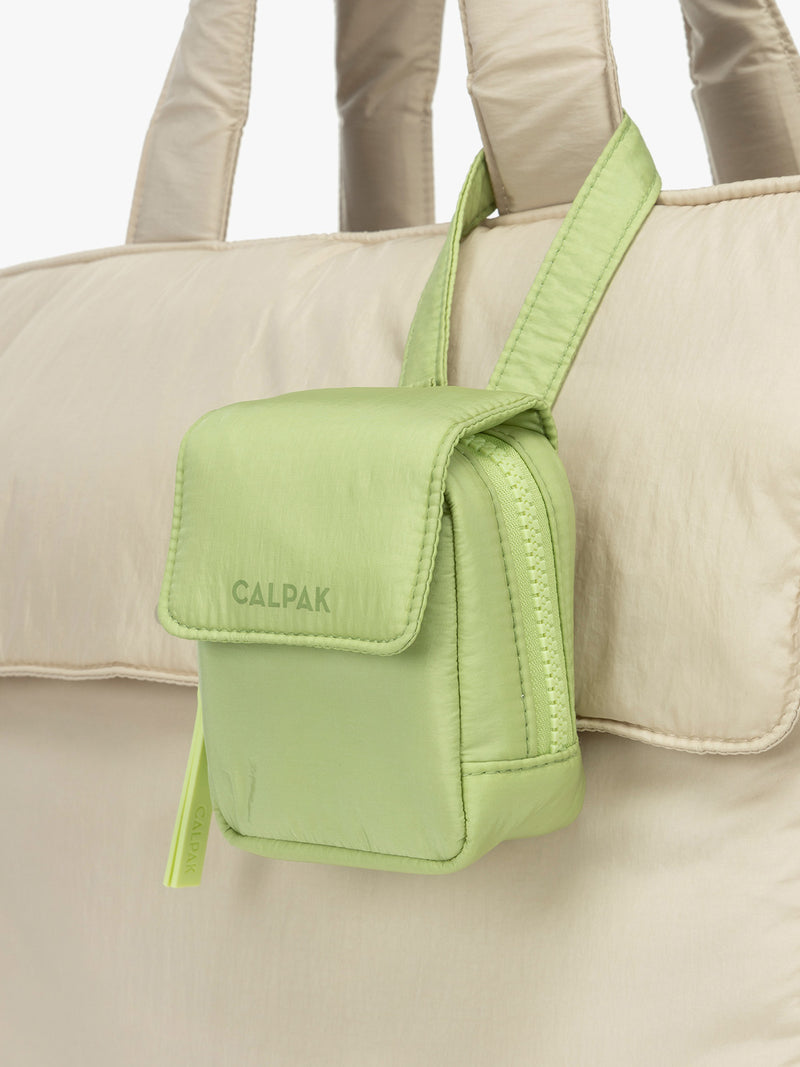 CALPAK Baby Collection Pacifier Pouch in light green Lime clipped onto white bag