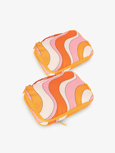 CALPAK small compression packing cubes in orange and pink wavy print; PCS2301-RETRO-SUNSET view 1