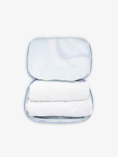 CALPAK small packing cubes for travel made with durable material in blue wavy print