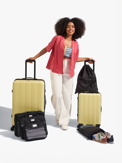 CALPAK starter bundle with carry-on, large luggage, packing cubes, pouches, and luggage tag in butter; LCO8000-BUTTER
