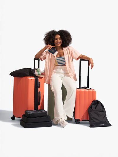 CALPAK starter bundle with carry-on, large luggage, packing cubes, pouches, and luggage tag in persimmon; LCO8000-PERSIMMON view 2