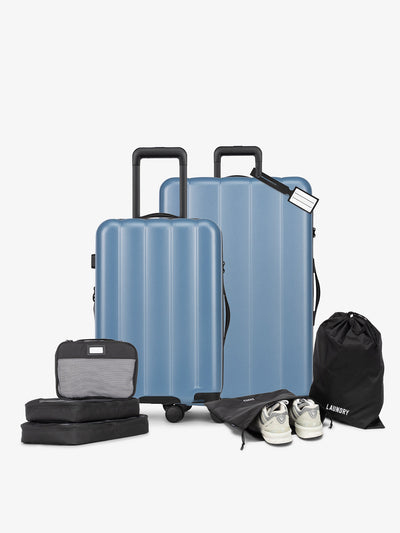 CALPAK Starter Luggage Set with Carry-On, Large Luggage, Packing Cubes, Pouches and Luggage tag in blue; LCO8000-MARINE