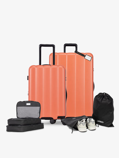 CALPAK starter bundle with carry-on, large luggage, packing cubes, pouches, and luggage tag in persimmon; LCO8000-PERSIMMON