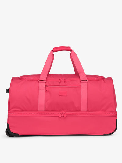 Hot pink CALPAK large rolling duffel bag featuring dual handles, zipper enclosed compartments, and shoe compartment