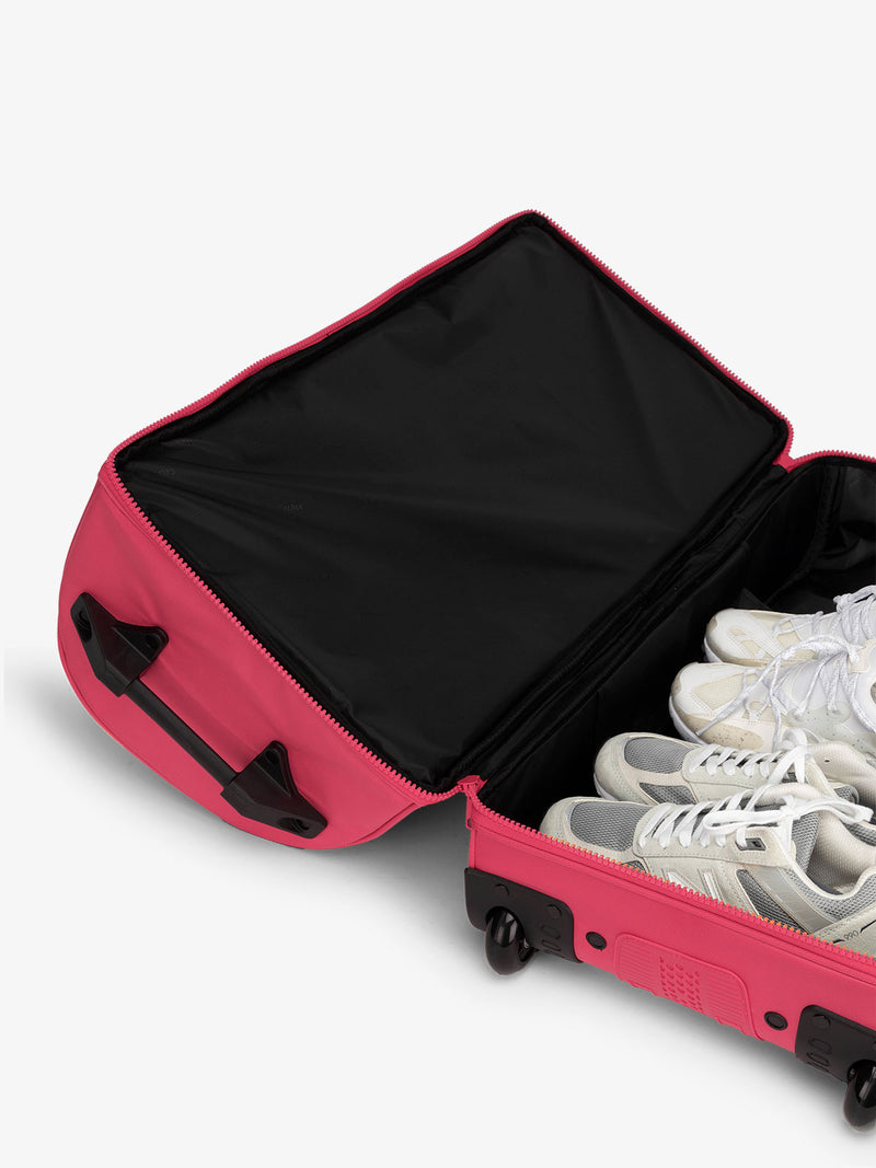 Shoe compartment interior of CALPAK Stevyn Large Rolling Duffel in dragonfruit