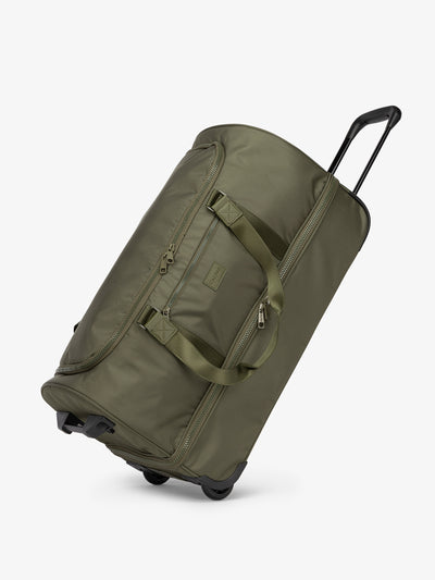 Side view of  CALPAK  large rolling travel duffel bag with wheels in dark green moss; DRL2301-MOSS