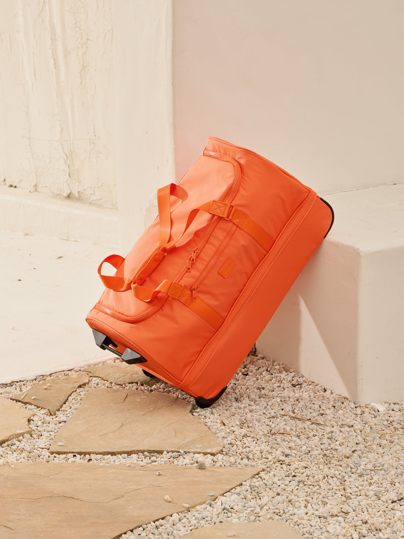 CALPAK Stevyn Large Rolling Duffel in orange