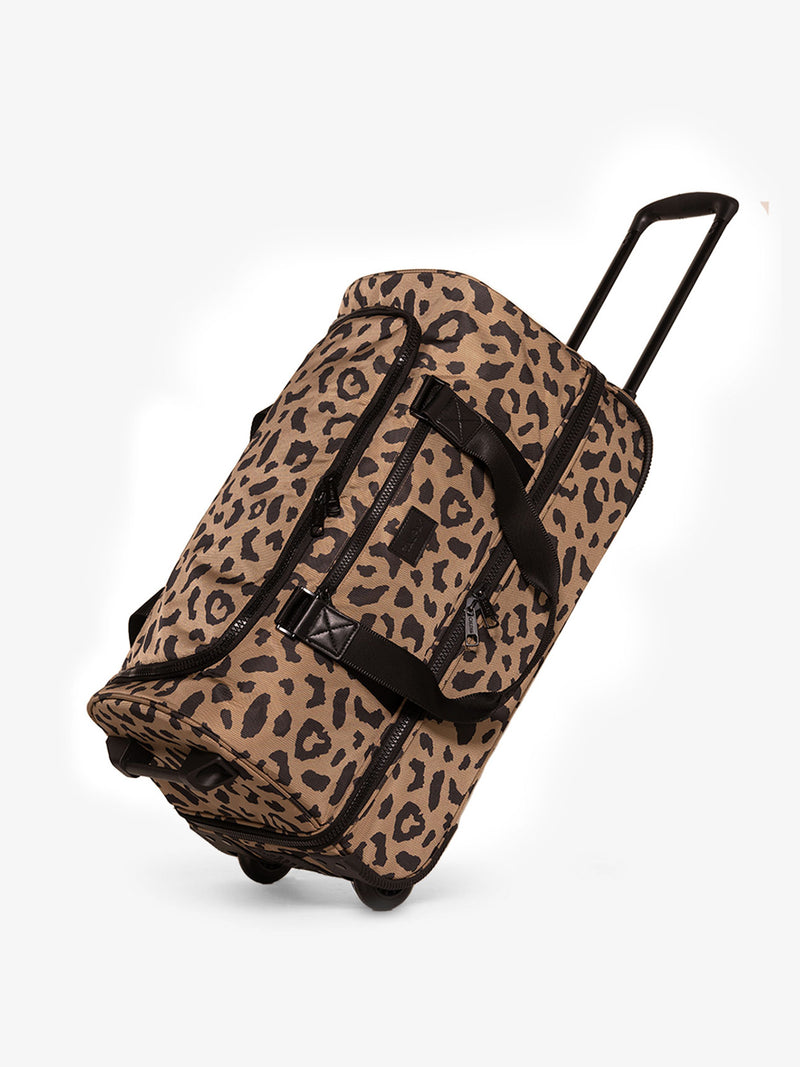 CALPAK Stevyn Rolling Duffel side view with top handle extended in cheetah