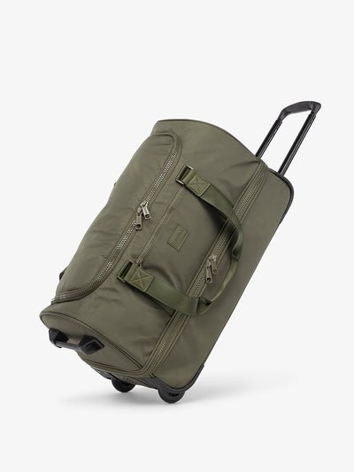 CALPAK Stevyn Rolling Duffel side view with top handle extended in moss; DSR2201-MOSS