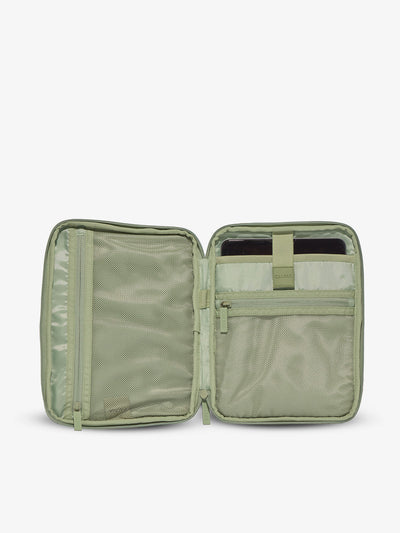 Interior of CALPAK  tablet organizer with zippered pockets and padded tablet sleeve in green daisy