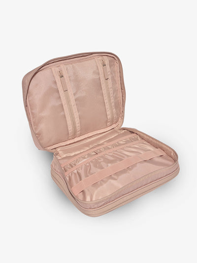 Pink tablet tech organizer features multiple pockets for organizing electronics and belongings by CALPAK