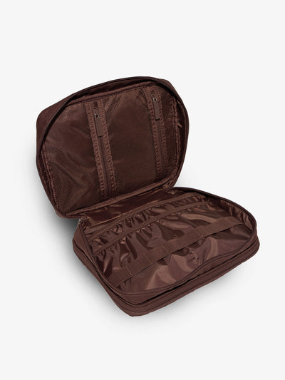 Brown tablet organizer features multiple pockets and loops for organizing belongings by CALPAK