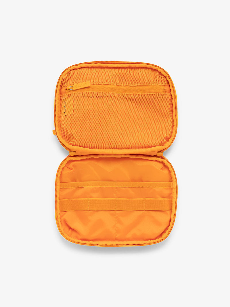 CALPAK tech and electronics organizer for travel in orange grid