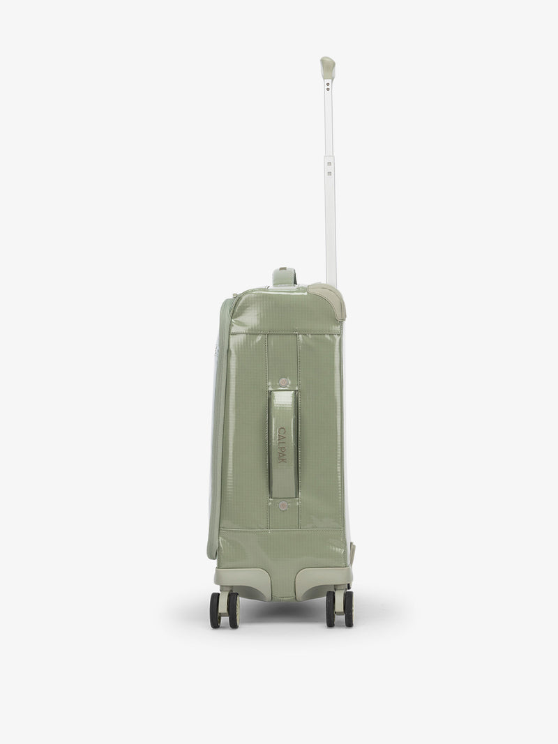 Studio product shot of side-facing CALPAK Terra 35L Carry-On luggage with soft shell and 360 spinner wheels in olive green