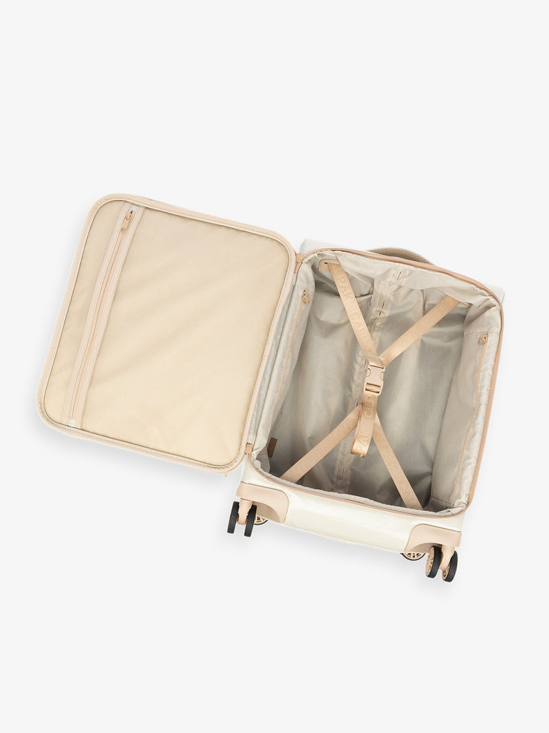 Studio product shot of interior compartment of CALPAK Terra 35L Carry-On luggage with soft shell and 360 spinner wheels in beige