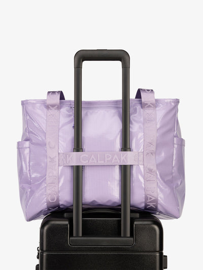 Luggage trolley sleeve of CALPAK Terra 35L Water Resistant Zippered Tote Bag in amethyst