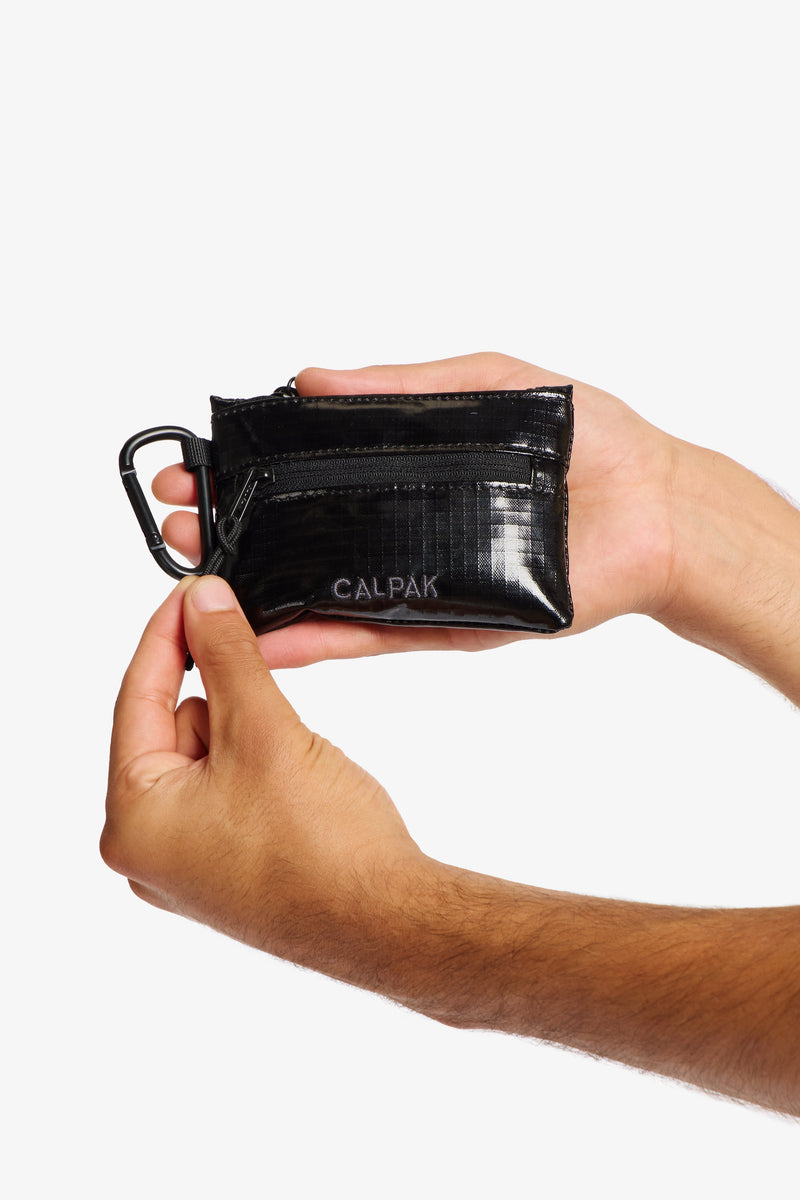 Model holding CALPAK Terra Clippable Card Pouch in Black