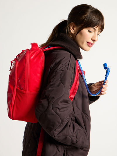 Front view of CALPAK Terra Hydration Backpack in flame red; BPT2201-FLAME
