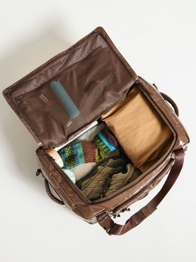 Interior of packed CALPAK terra large 50L duffel backpack in brown