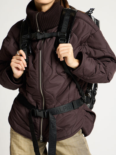 Model displaying adjustable sternum strap of black CALPAK terra large 50L duffel backpack