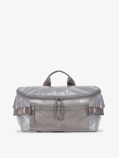 CALPAK Terra Sling Bag with mesh front pocket and top handle in gray storm