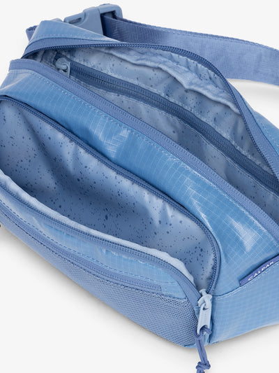CALPAK Terra small belt bag with multiple interior pockets and water resistant exterior in glacier blue
