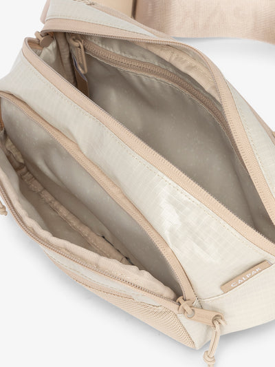 CALPAK Terra small belt bag with multiple interior pockets and water resistant exterior in white sands