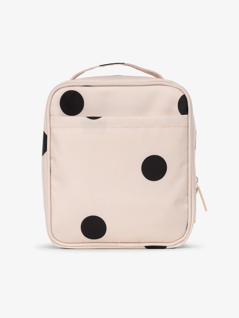 Backview of CALPAK The Everything Cube with exterior back slip pocket in black and white polka dot print