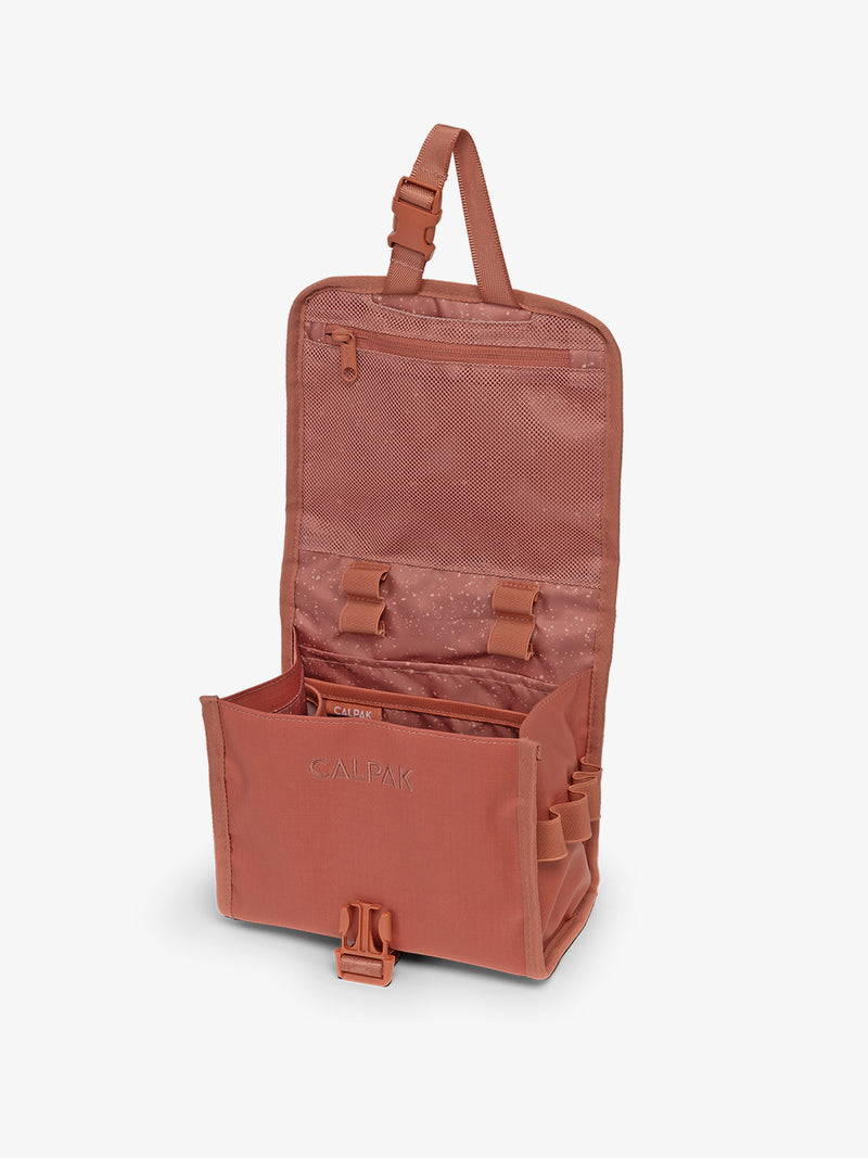 CALPAK Terra Hanging Toiletry Bag in red and orange Matte Clay open top hanging view