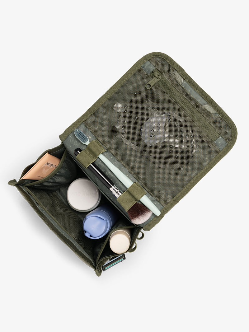 CALPAK Terra Hanging Toiletry Bag in dark green Matte Pine open top with toiletries