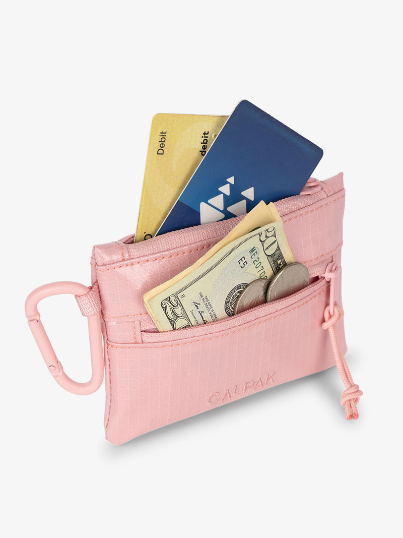 CALPAK Terra Clippable Card Pouch in pink Blossom being used as cash and card wallet