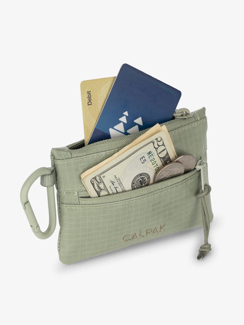 CALPAK Terra Clippable Card Pouch in olive green Juniper being used as card and cash wallet