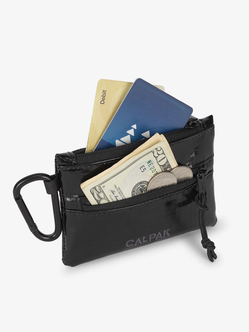 CALPAK Terra Clippable Card Pouch in Black being used for card and cash wallet