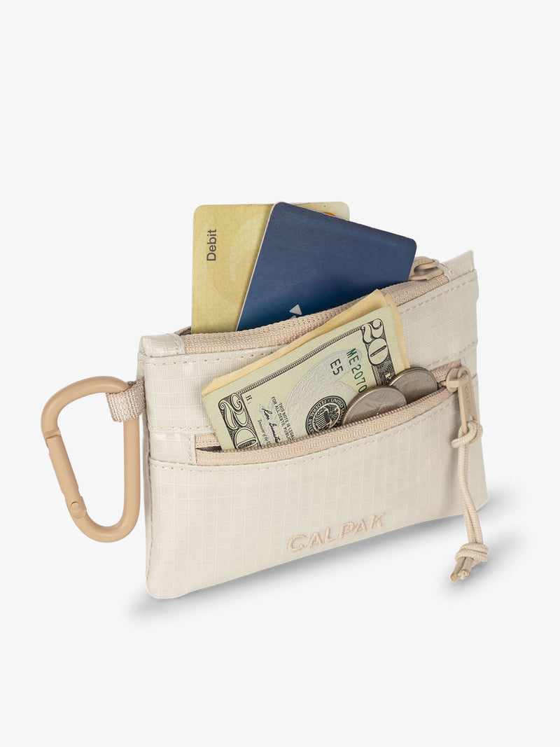 CALPAK Terra Clippable Card Pouch in off-white and tan White Sands being used as card and cash wallet