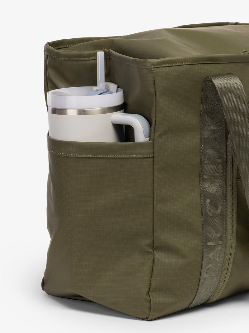 CALPAK Terra 35L Water Resistant Zippered Tote Bag in dark green Matte Pine side pocket used as as water bottle holder