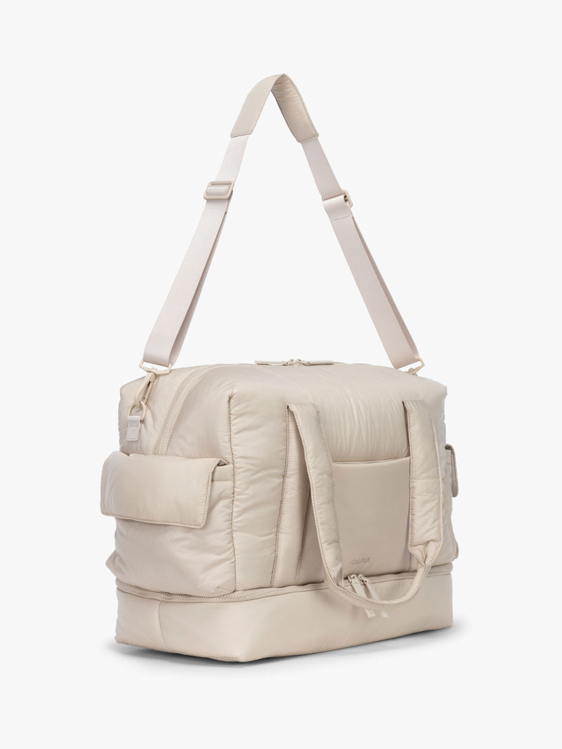 CALPAK Weekender Duffel side view in white Oatmeal