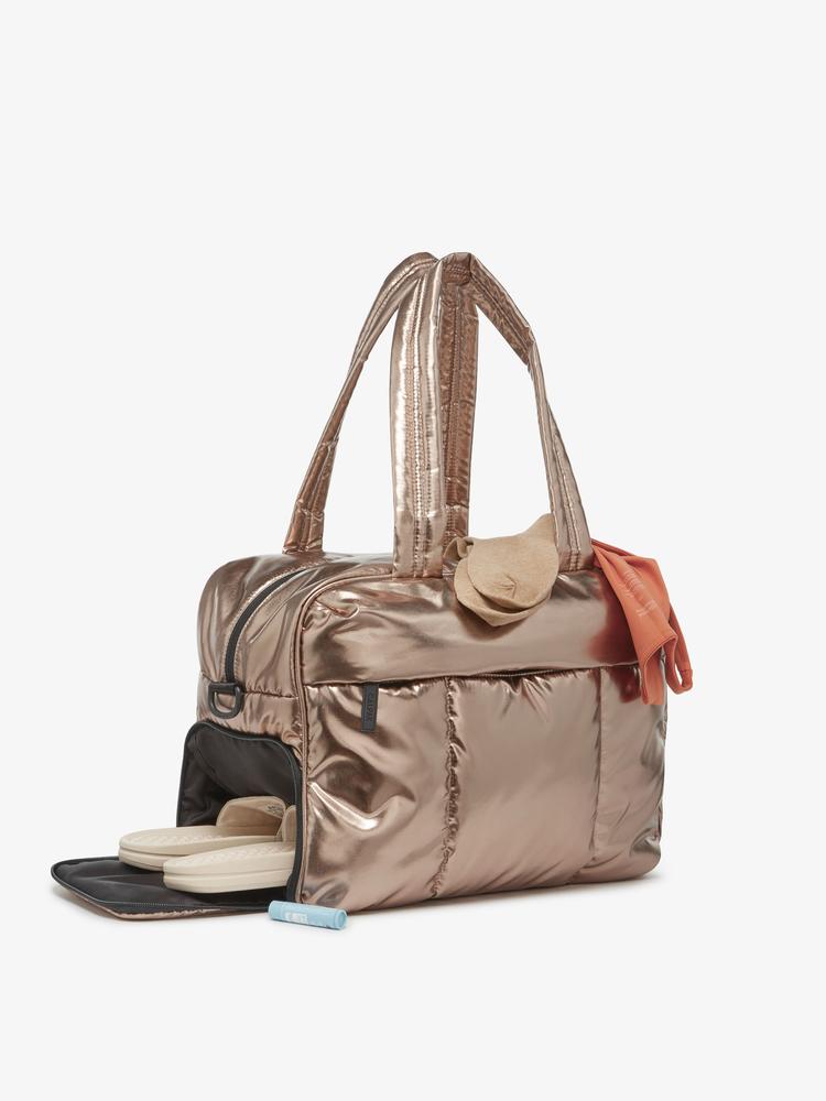 shoe compartment in a gold bronze CALPAK Luka duffel bag