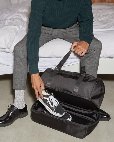 shoe compartment in black CALPAK Stevyn duffel bag