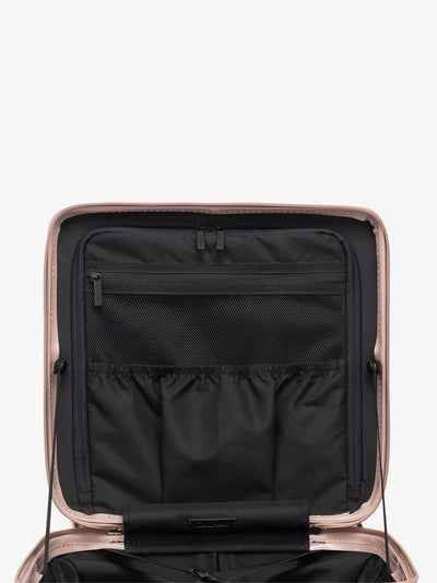 CALPAK Ambuer small wheeled carry on with multiple interior pockets and compression straps in rose gold