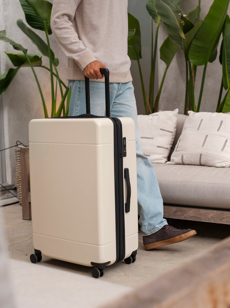 CALPAK Hue large 30 inch hard shell spinner suitcase in cream linen