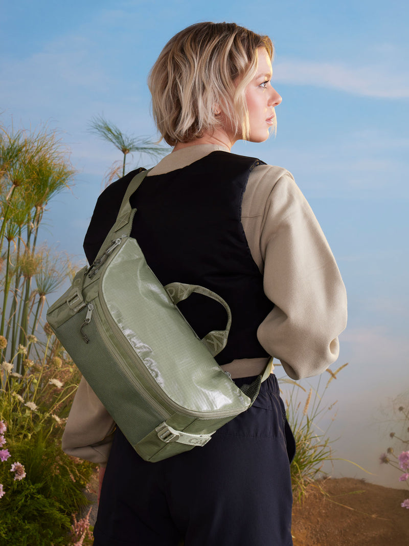 woman with CALPAK sling shoulder bag